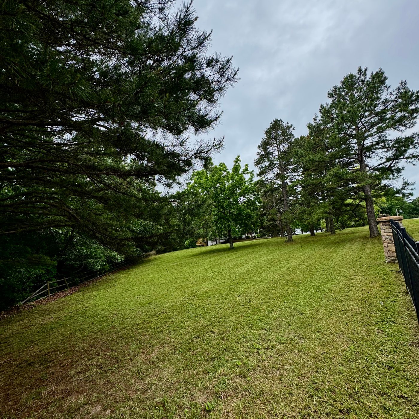 Large property with stone and iron fencing