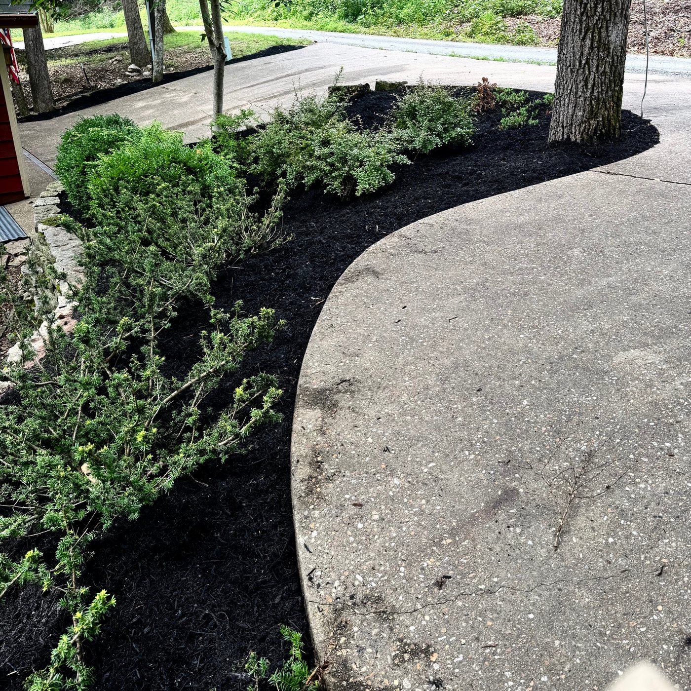 Freshly mulched bed with clean edges along a driveway